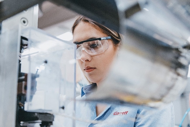 Garret employee with safety googles working in a laboratory